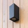 black front lamp on the wooden facade of a house with rain or dew drops AXIS GRAY SIENINIS ŠVIESTUVAS 2XGU10